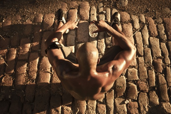 African American man drinking water after exercise