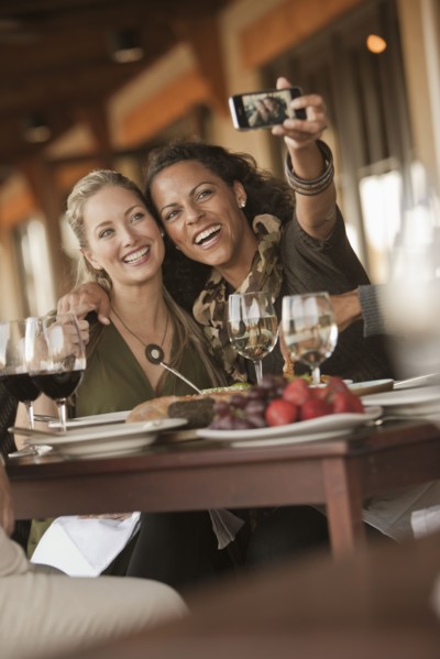 Women taking self-portrait in restaurant