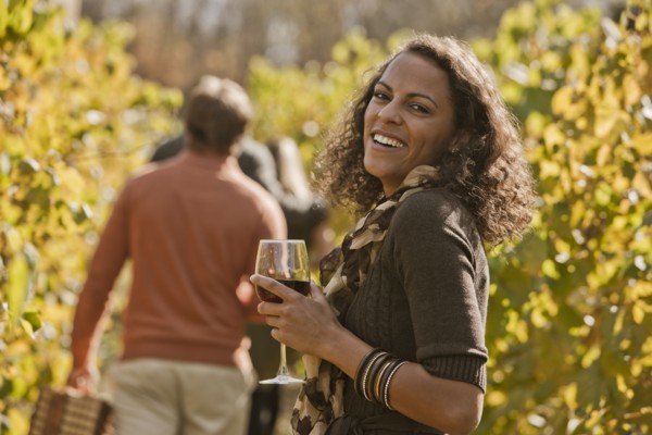 Friends drinking wine in vineyard