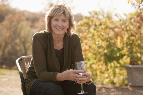 Caucasian woman drinking wine outdoors