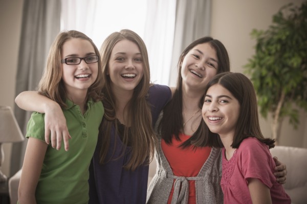 Grinning friends hugging