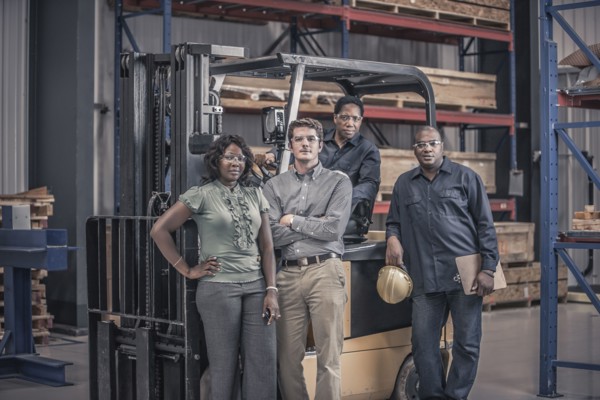 Workers with forklift in factory