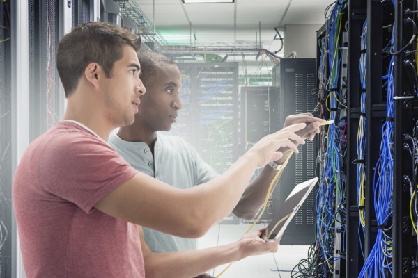 Businessmen working in server room