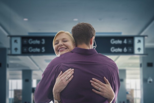 Caucasian hugging in airport