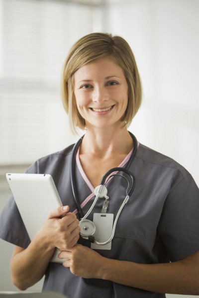 Caucasian nurse holding digital tablet