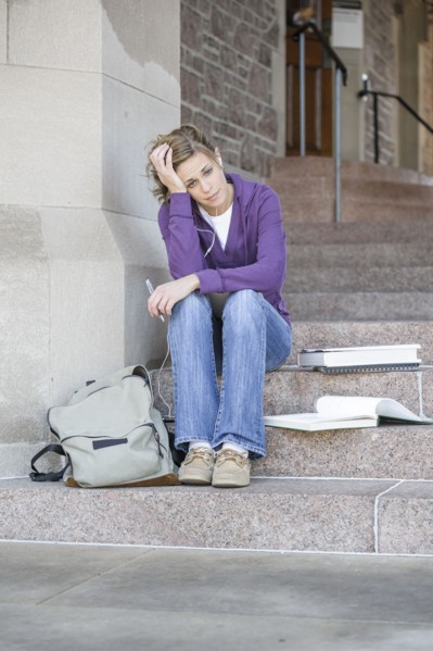 Caucasian student sitting on campus