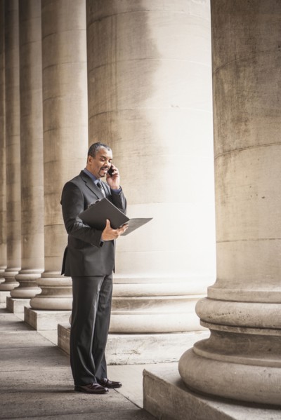 Mixed race businessman talking on cell phone