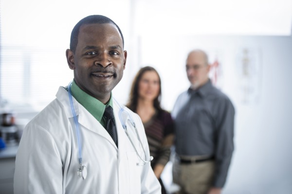 Doctor and patients standing in office