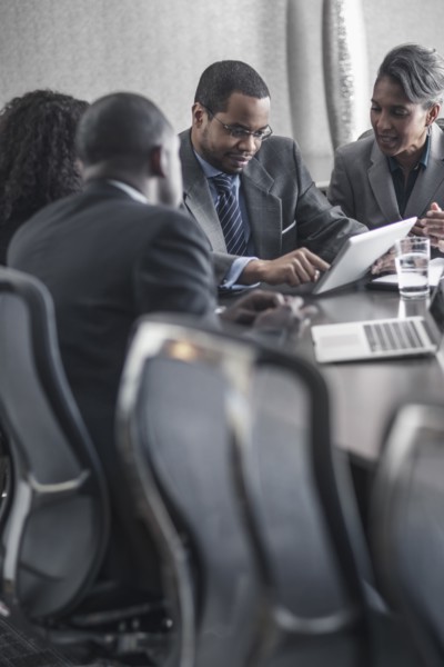Business people using digital tablet in meeting