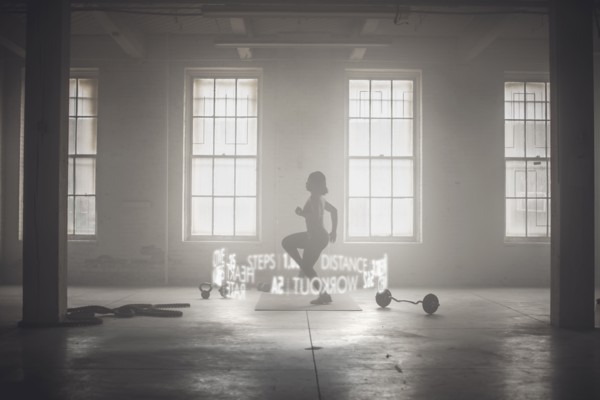 Virtual words circling Black athlete while working out