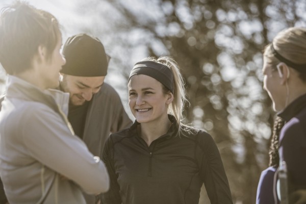Smiling friends talking outdoors
