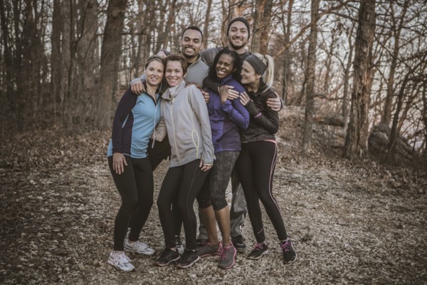 Runners smiling on forest path