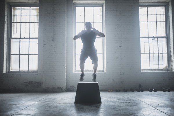 Athlete jumping on platform