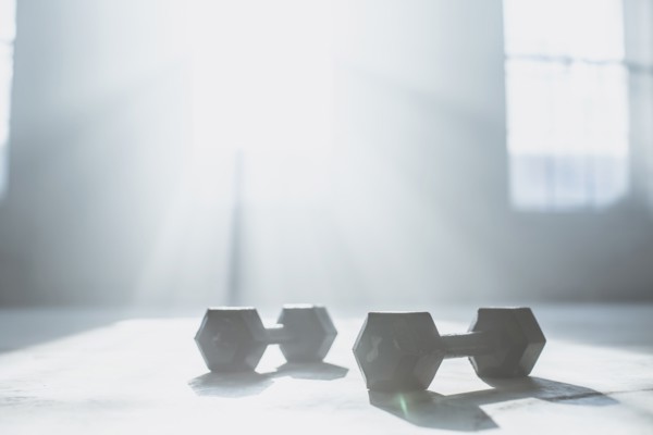 Dumbbell weights on floor in sunlight