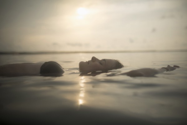 Caucasian woman floating in still lake