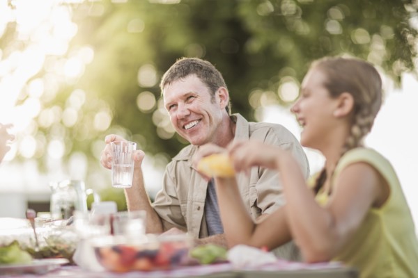 Caucasian family eating in backyard