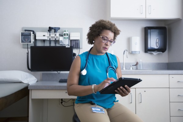 African American doctor using digital tablet