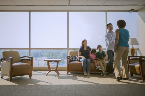 Doctor greeting patients in waiting room