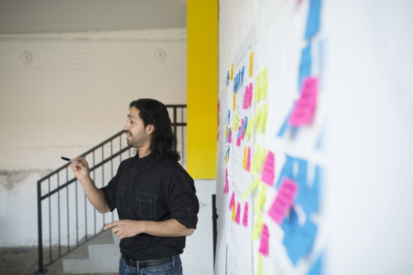 Mixed race businessman talking in office meeting