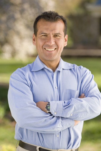 Hispanic man with arms crossed