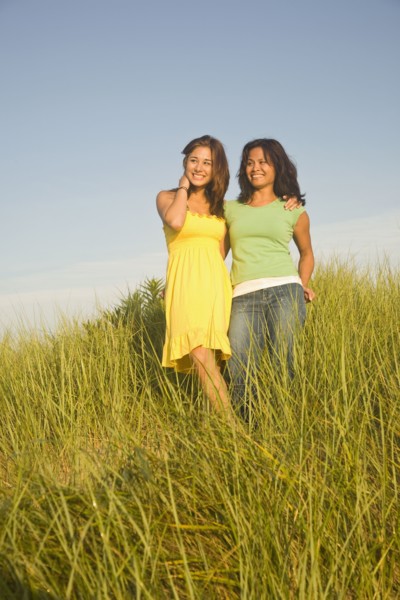 Asian mother and daughter in dune grass