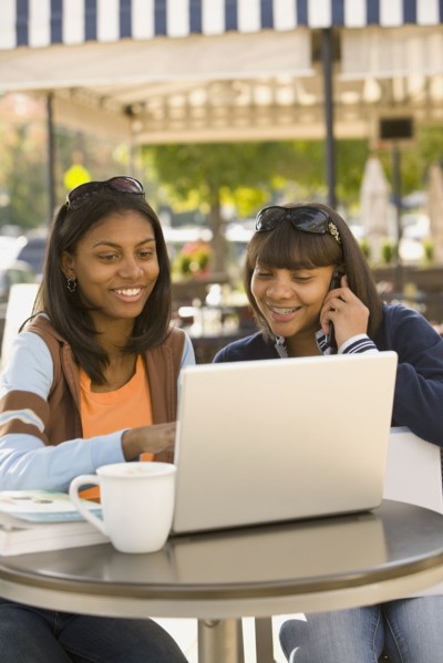 African teenaged girls looking at laptop