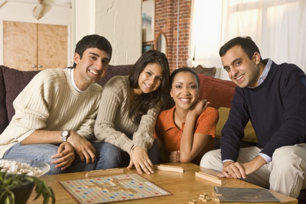 Multi-ethnic family playing board game