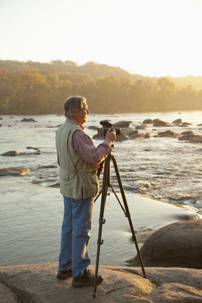 Man taking photographs on beach