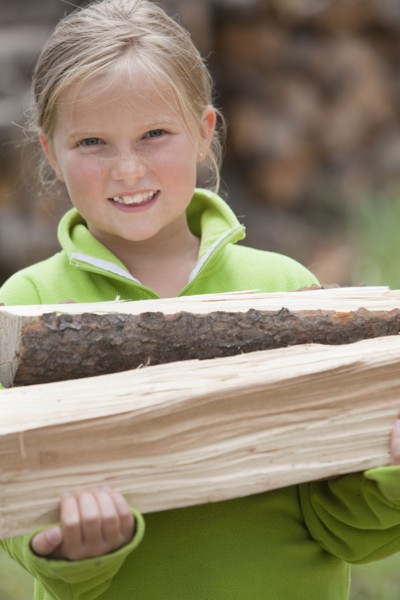 Caucasian girl carrying firewood