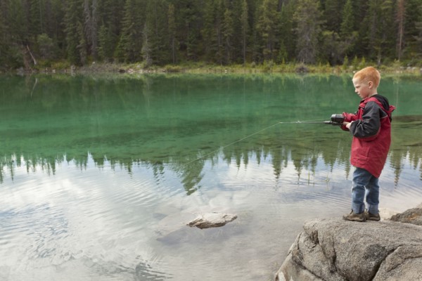 Caucasian boy fishing in the Valley of the Five Lakes