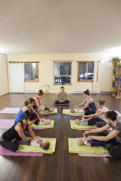Mothers and babies taking yoga class