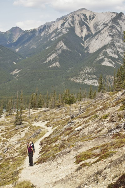 Caucasian mother and son hiking on remote hillside