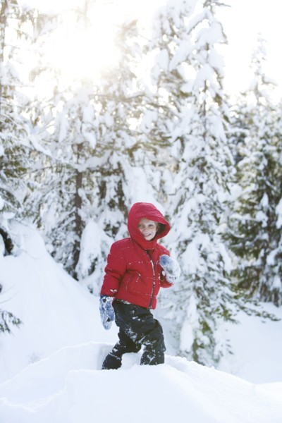 Caucasian boy snowshoeing on hillside