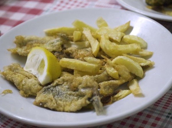Plate of fried fish and french fries with lemon