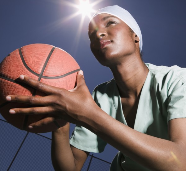 African woman holding basketball