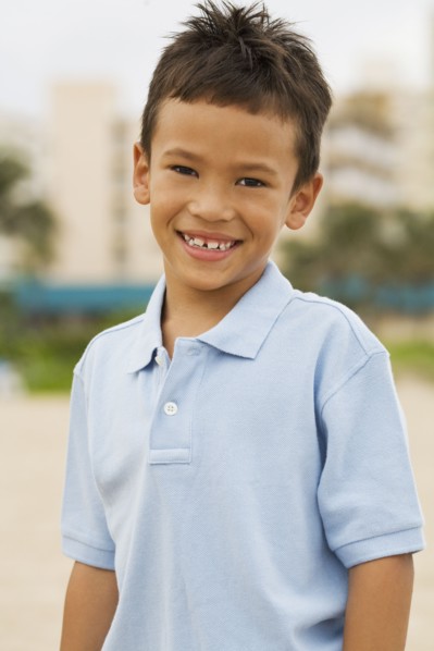 Mixed race boy smiling on beach