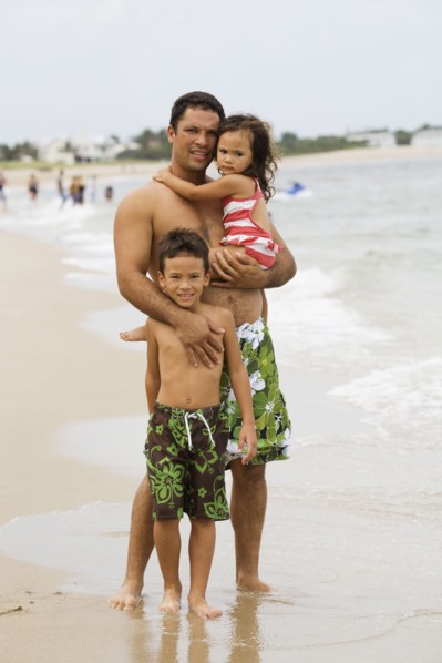 Father with daughter and son on beach