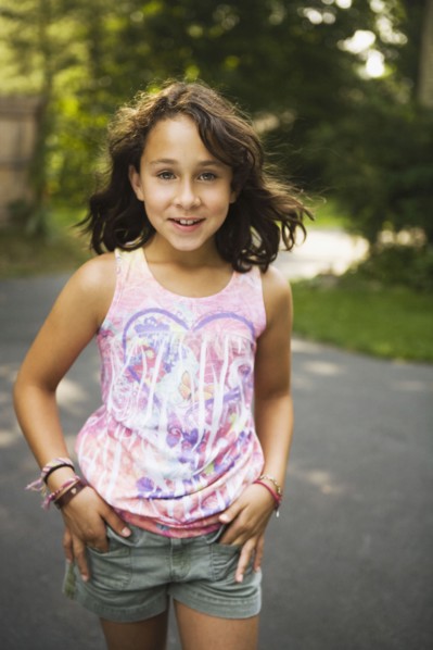 Mixed race girl walking on road