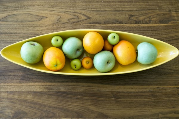 Bowl with fruit on wooden table