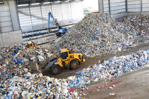 Bulldozer pushing pile of trash