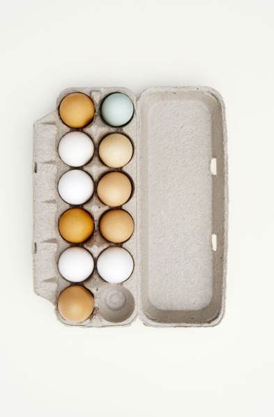 Colored eggs in egg carton