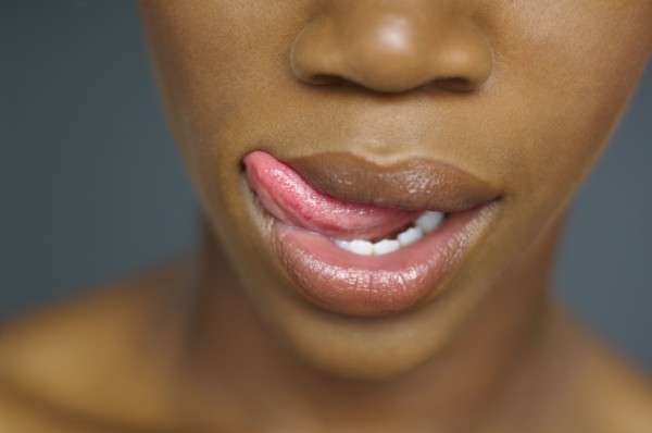 Close up of African woman licking lips