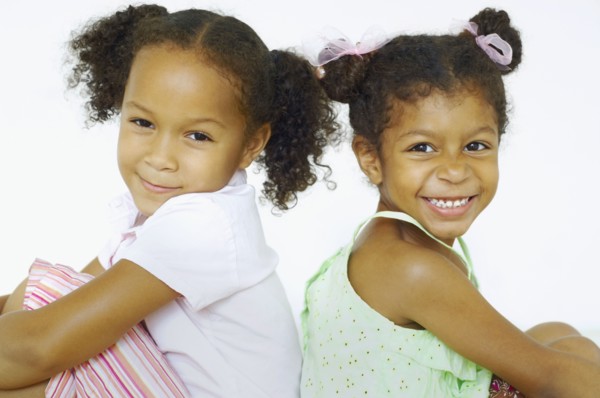 Multi-ethnic girls sitting back to back