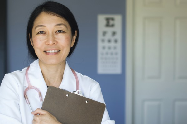 Japanese doctor standing in office