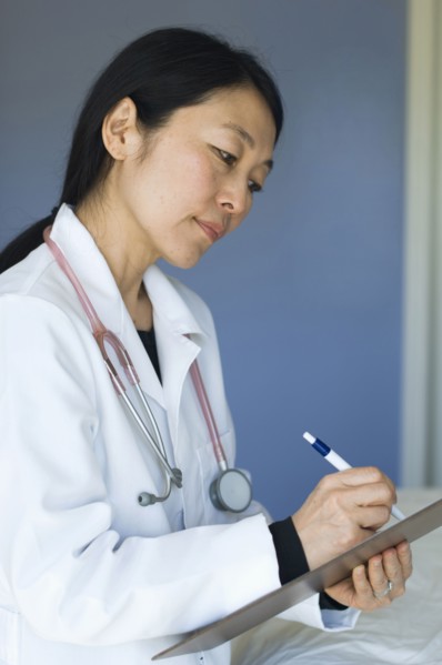 Japanese doctor writing on clipboard