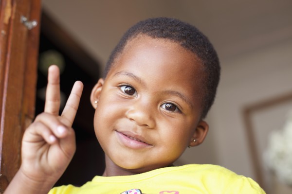Mixed race girl giving peace sign