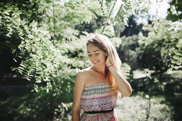 Caucasian woman standing near trees