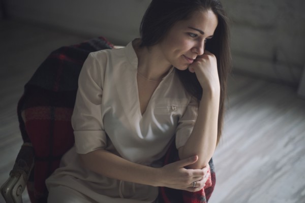 Pensive Caucasian woman sitting in chair