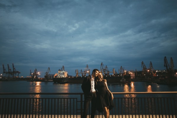 Caucasian couple hugging at waterfront