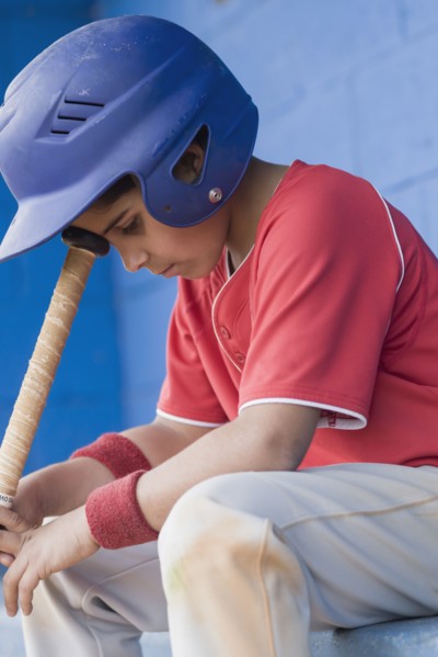 Sad Hispanic baseball player